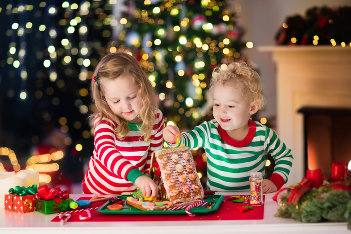 two little kids prep for Christmas decorations