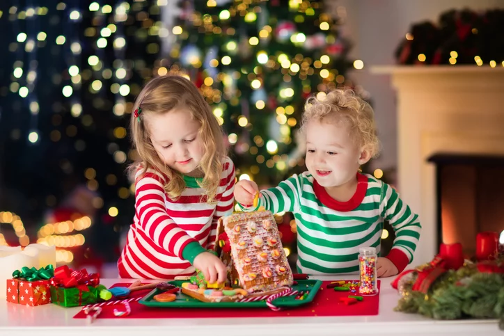 two little kids prep for Christmas decorations