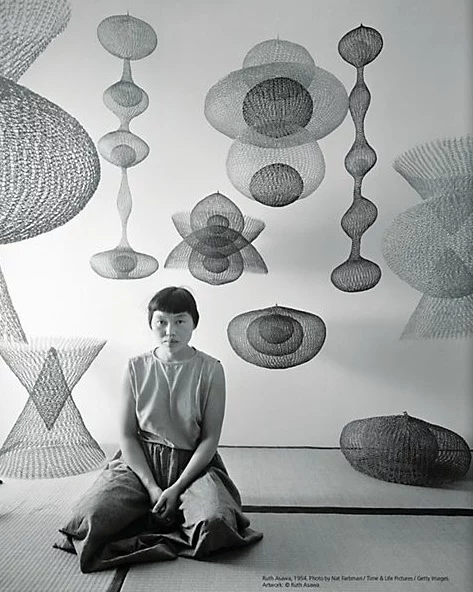 Ruth Azawa posing next to her creations