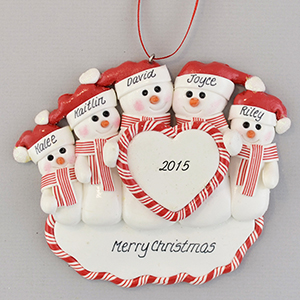 handmade clay Christmas ornament with five snowmen in santa hats holding a heart with the year 2015 painted in it.